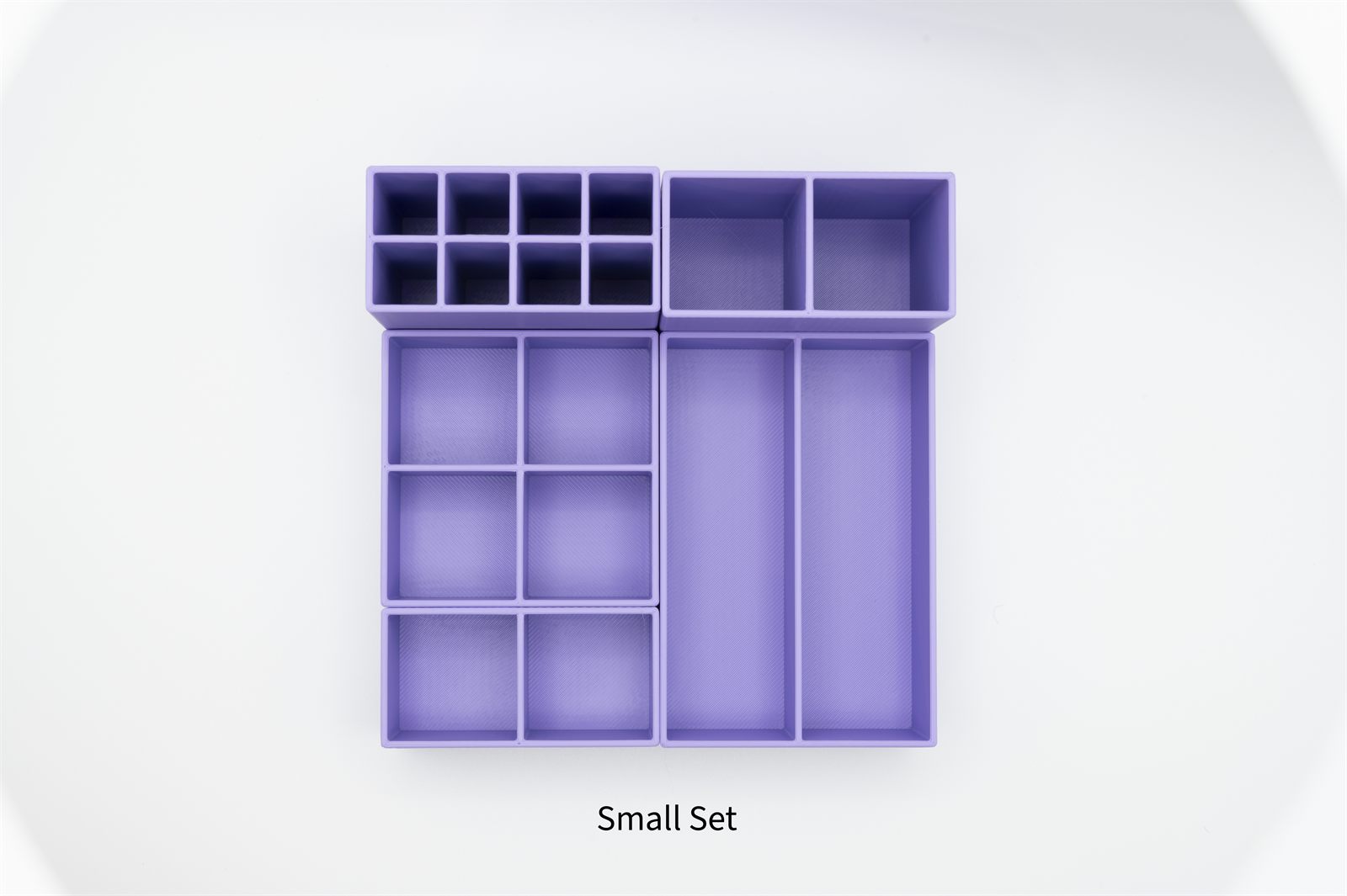 Pink modular makeup organizer holding lip products, brushes, and palettes